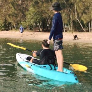 Two kids on a viking espri, one standing on the rear