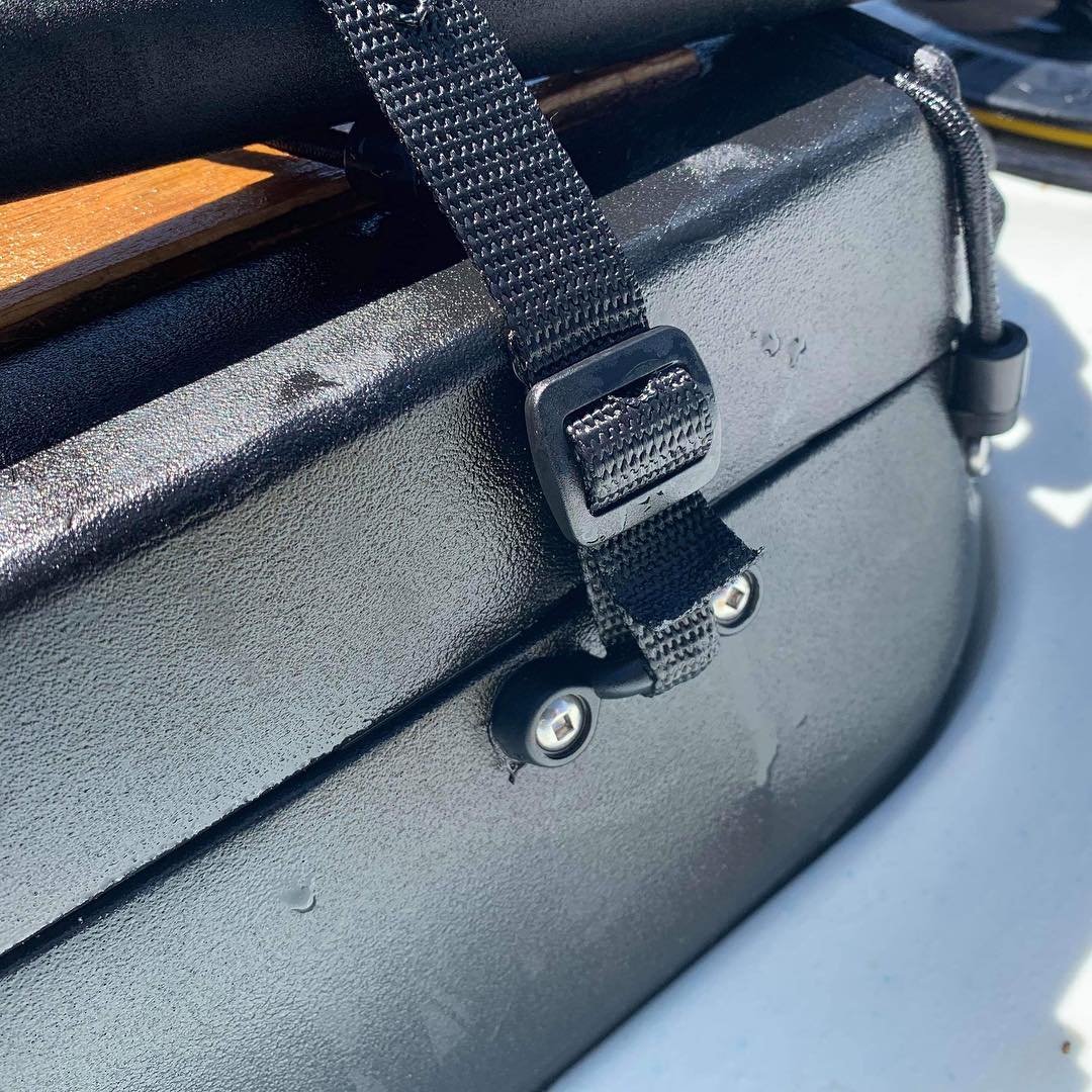 Close-up of a modified strap and toggle system on the viking profish reload tackle pod for secure surf launches.