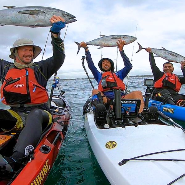 Kayak angler reeling in a fish during a guided lesson