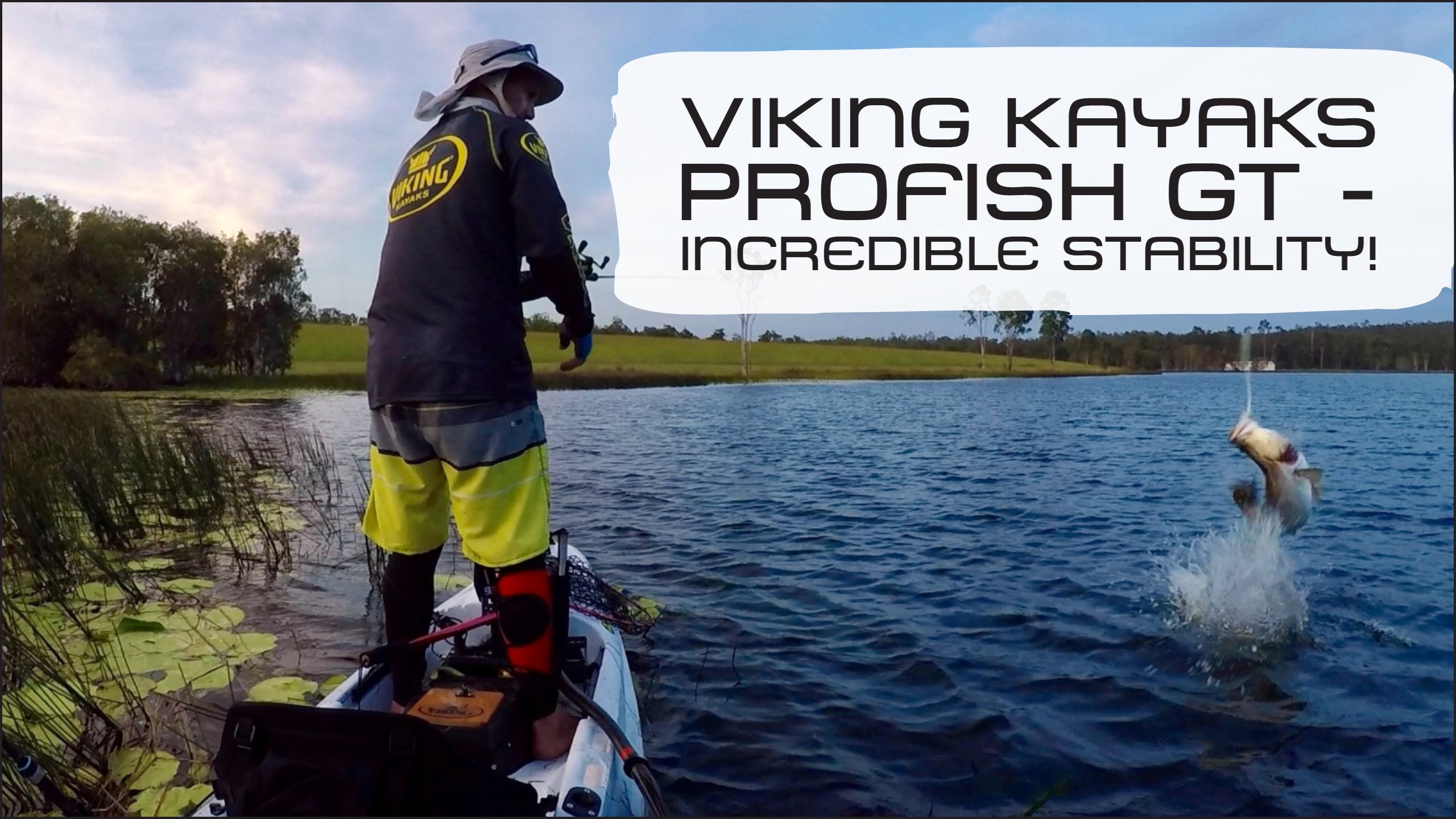 Paddle guy angler standing on profish gt while landing a fish