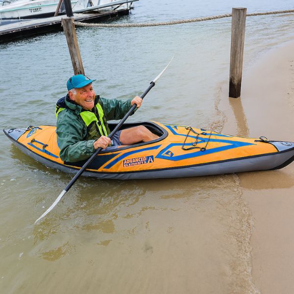 Older man testing a kayak on calm waters