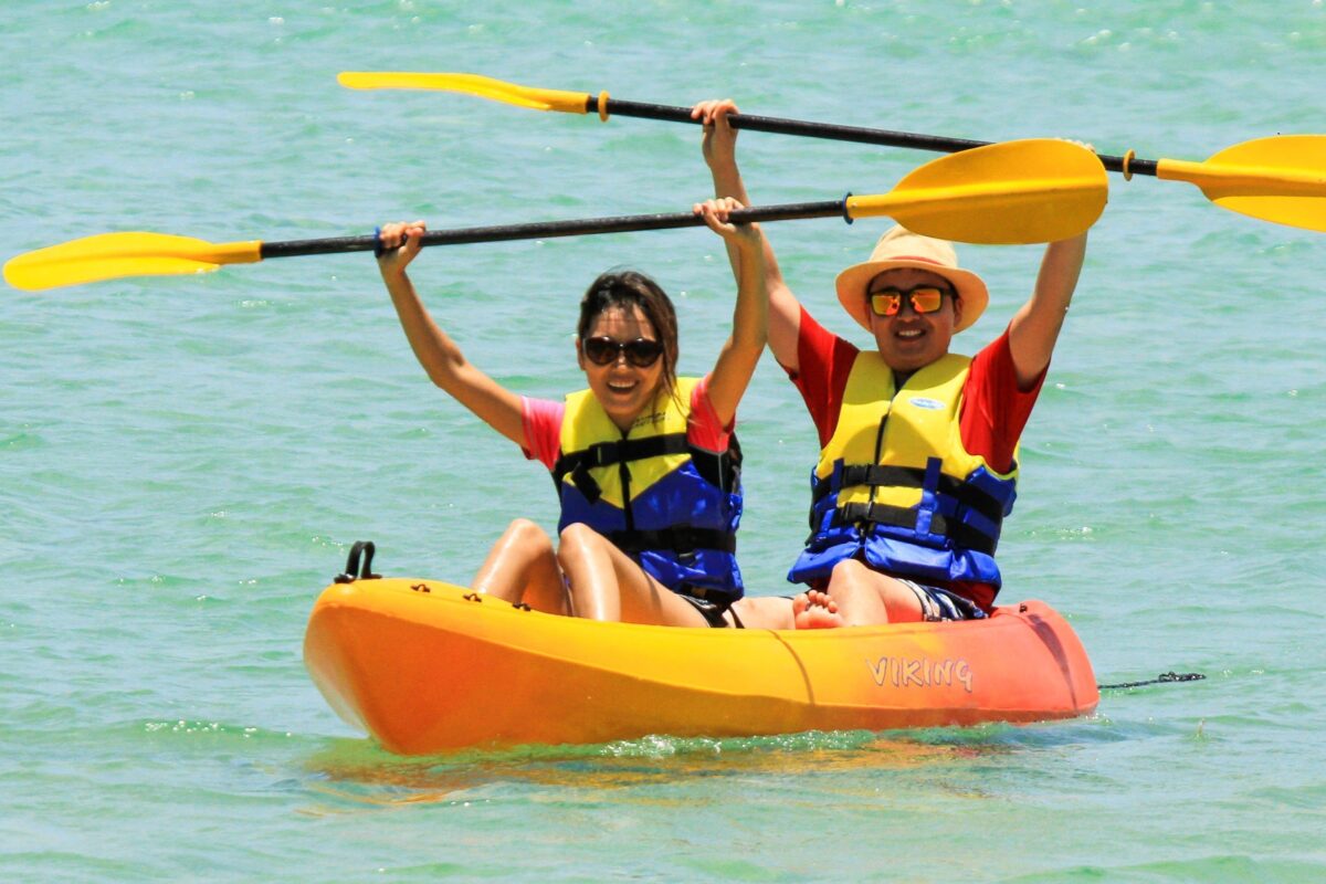 Happy couple kayaking in clear Noosa waters with Viking Kayaks