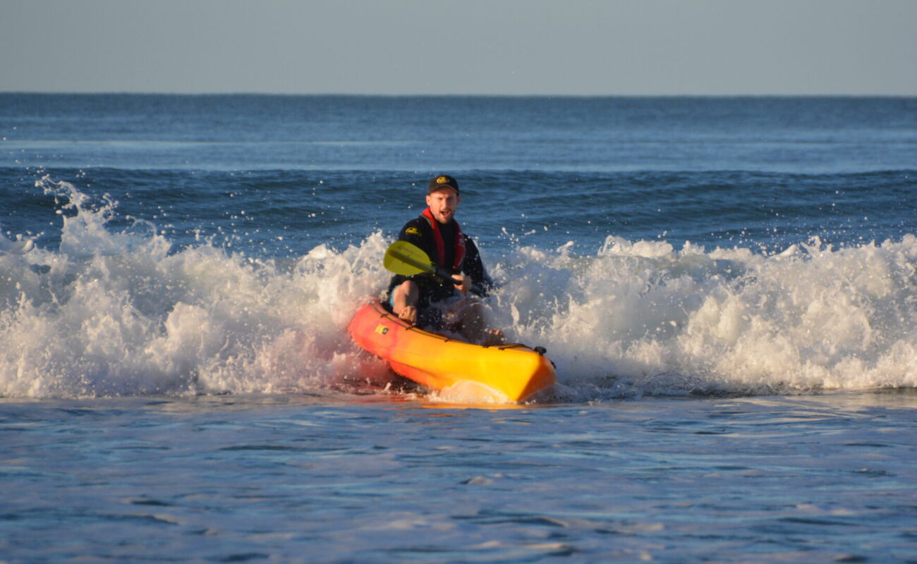 Viking 2+1 in sunset colour with Jason Milne, aka Paddle Guy, surfing waves in the ocean