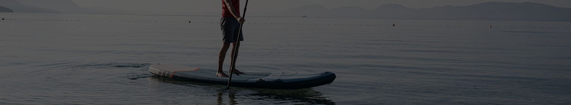Person paddling on an inflatable SUP board at sunrise – Kayak and SUP Sunshine Coast