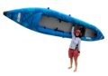 Woman lifting a blue Jaspara Quest Tandem kayak over her head — lightweight inflatable design ideal for family and touring adventures.