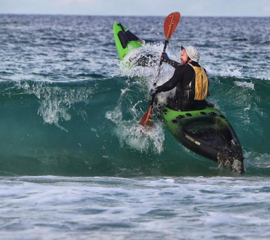 Jason mill paddling the new viking profish 400 through surf waves during field testing